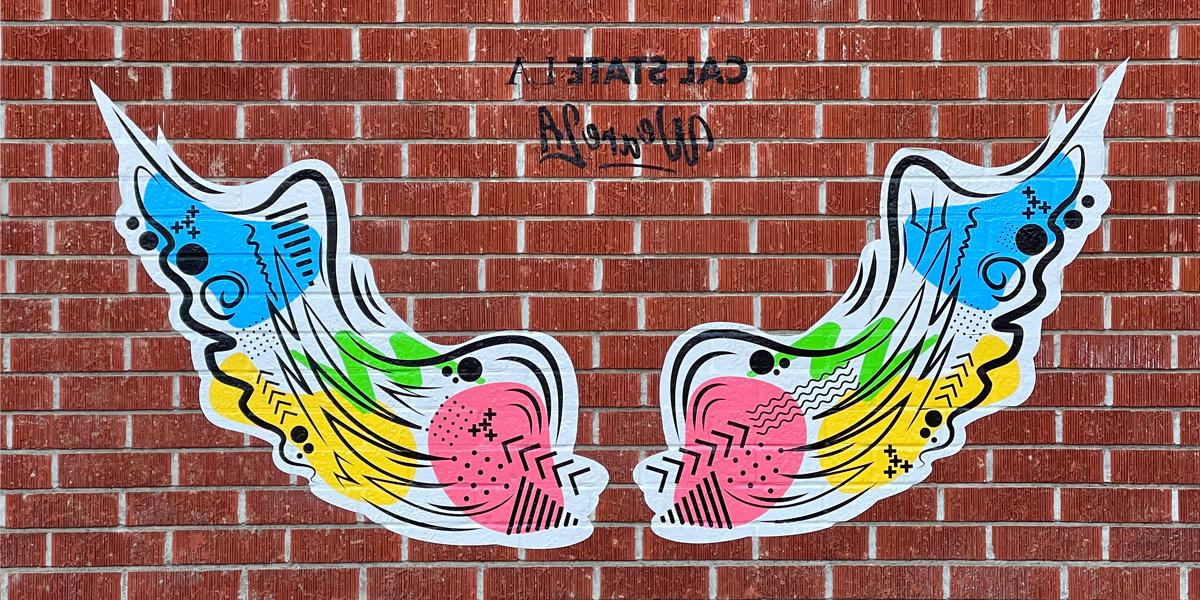 Artistic interpretation of wings on a brick wall in front of the ECST building.