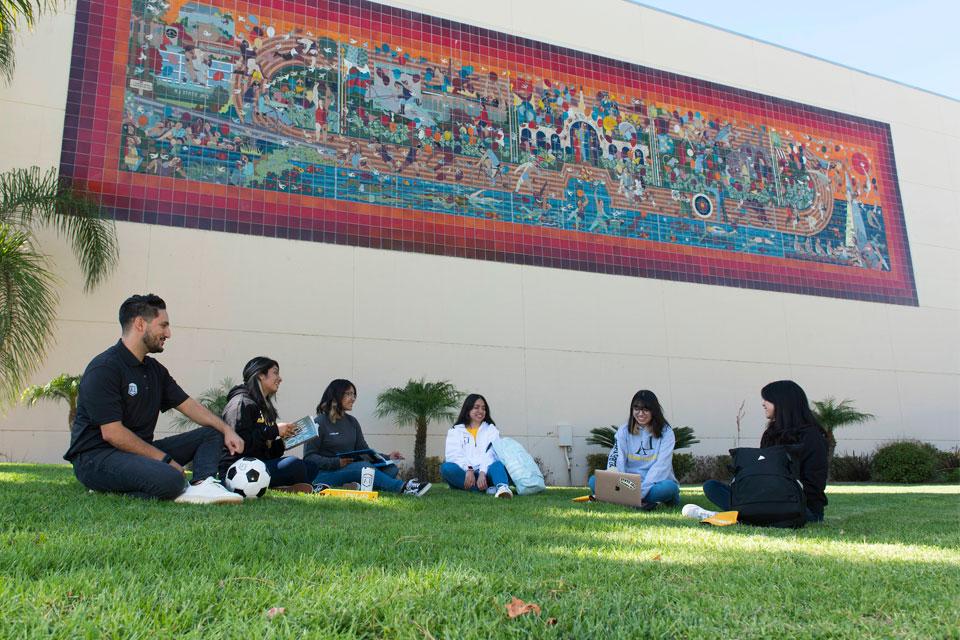 Cal State LA students hanging out on campus nearby the university's Physical Education building.