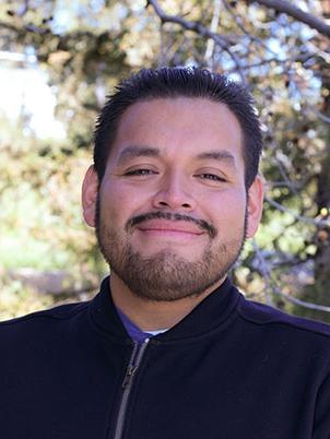 Man smiling and posing for a portrait.