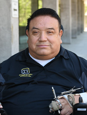 Man smiling to camera in Cal State LA shirt.