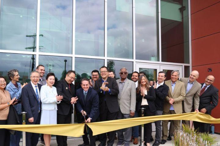 county officials and staff pose for ribbon ceremony 