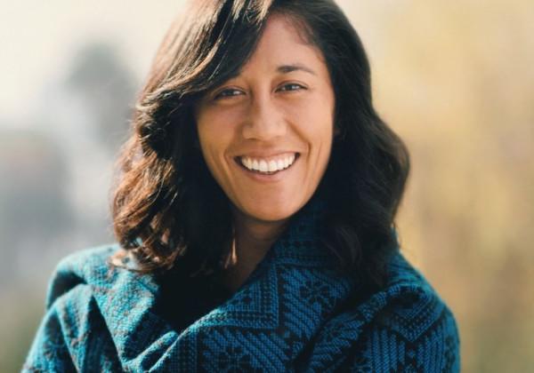 Woman smiling and wearing green clothing