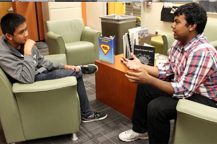 two EEp students engaged in conversation in lounge area.