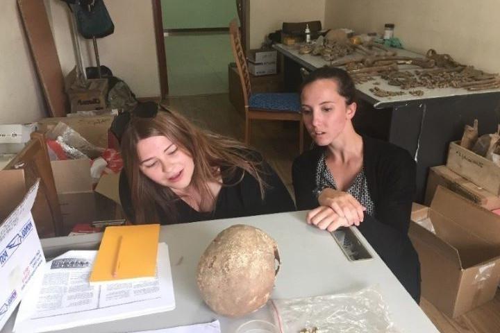 Amaretta and Jennifer examine a skull