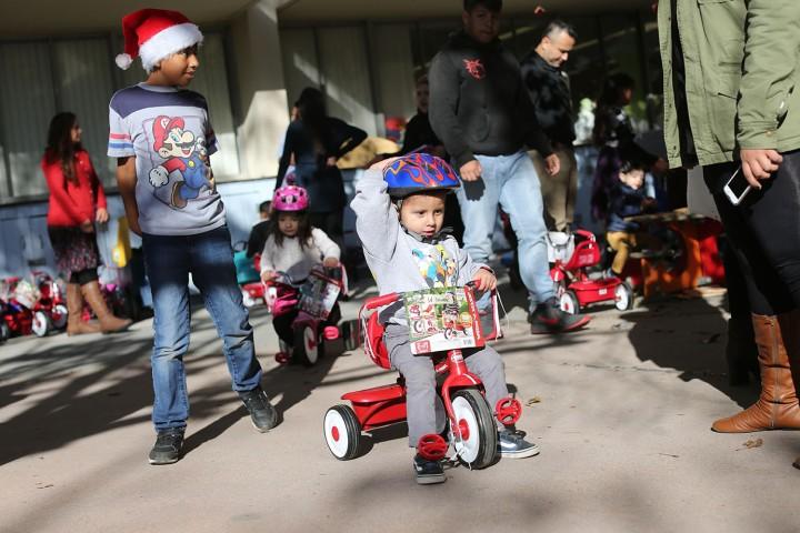 A small child on a tricycle.