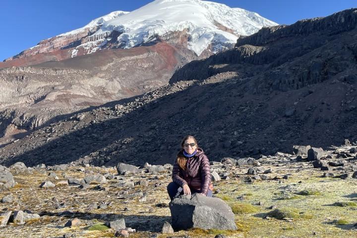 Cal State LA Professor Jennifer Garrison sits in front of a large mountain.