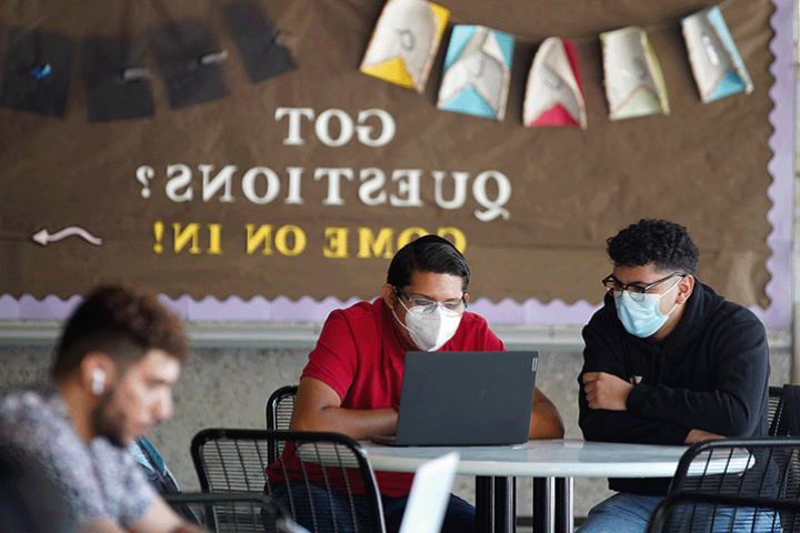 Two students reading a syllabus together