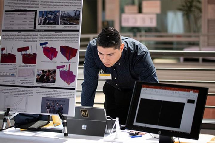 person next to computer and electronics