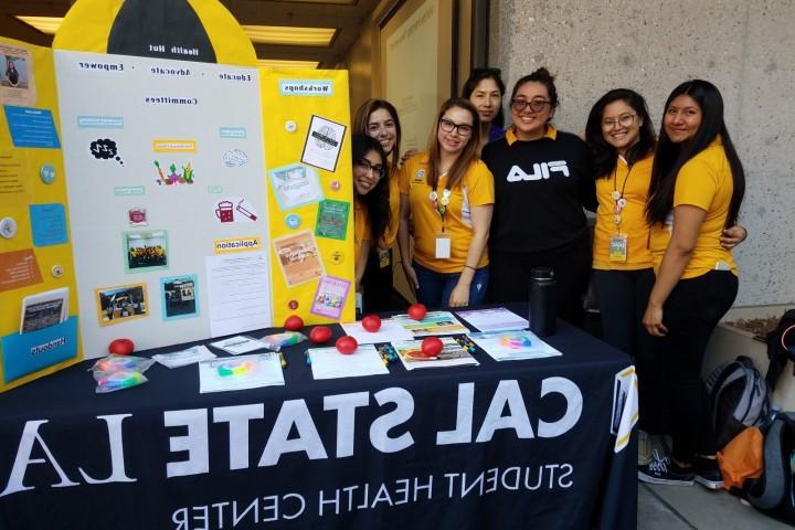 Students at a table showing a research project