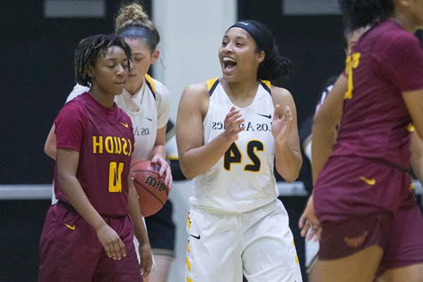 Image of the Cal State LA women's basketball team on the court mid-game. 