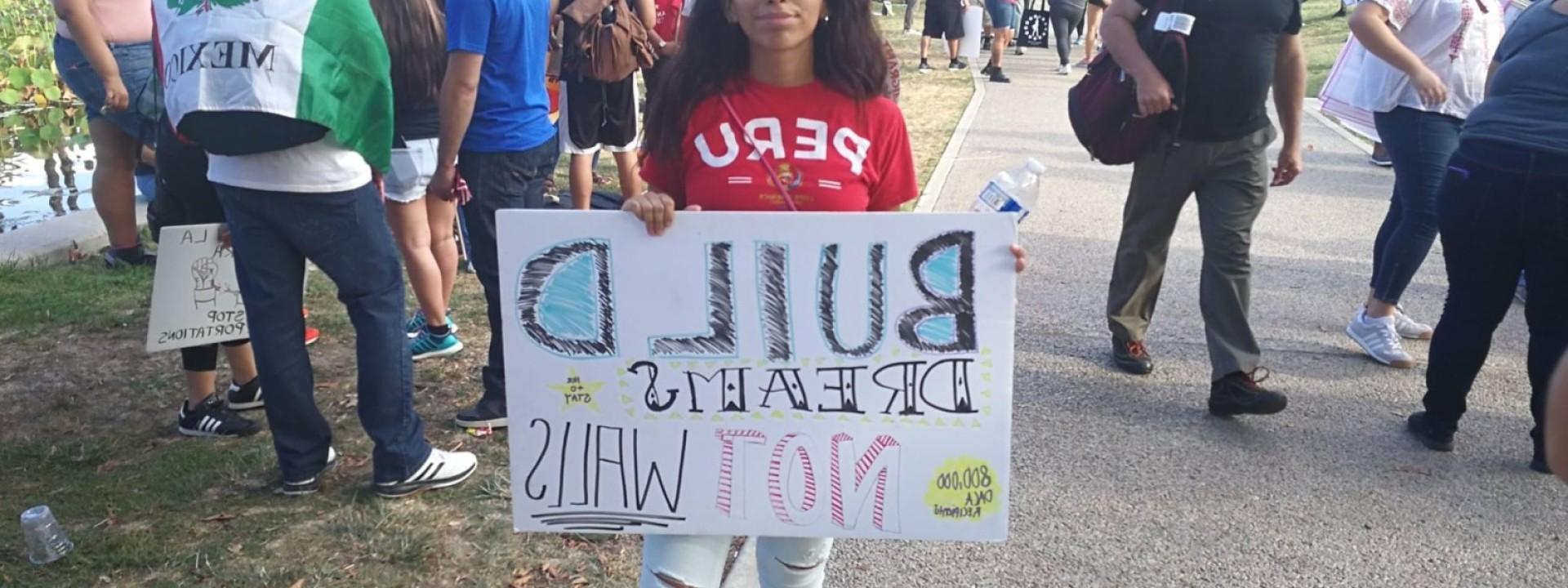 student holding a banner